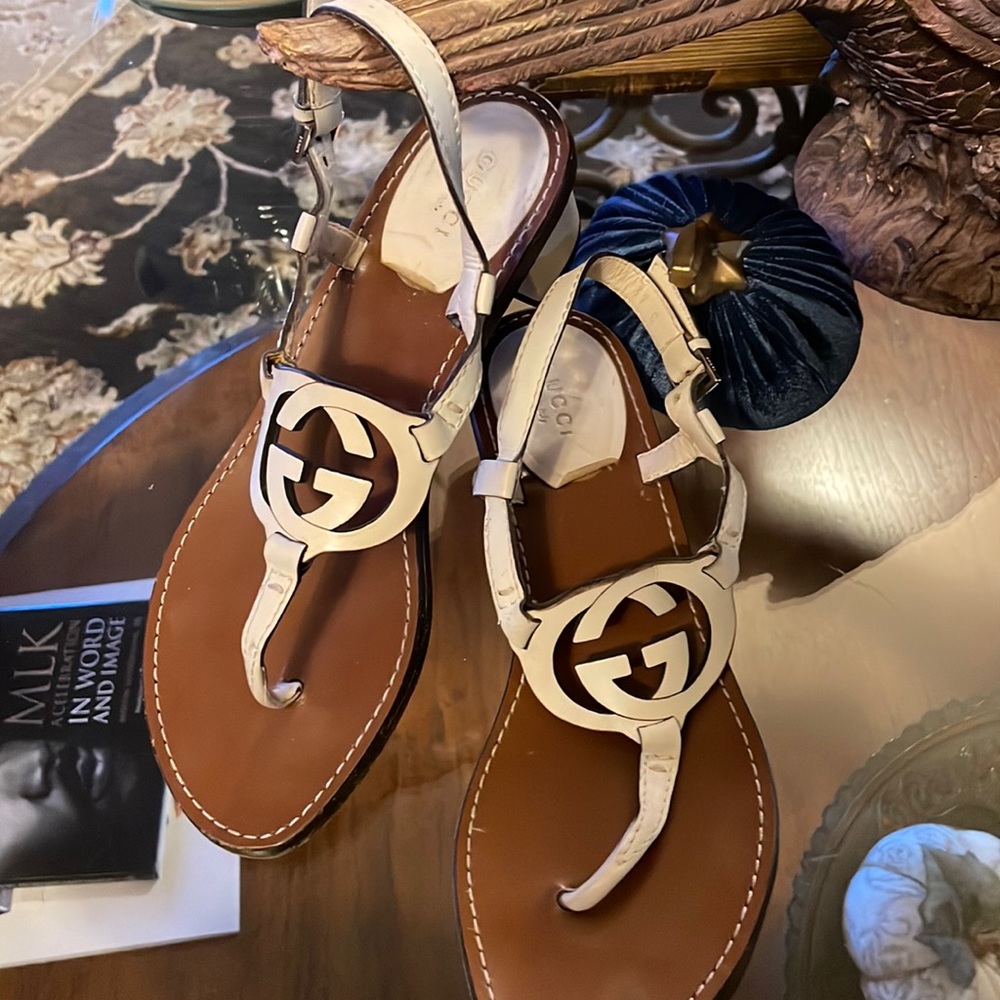Cream colored block heeled Gucci sandals.